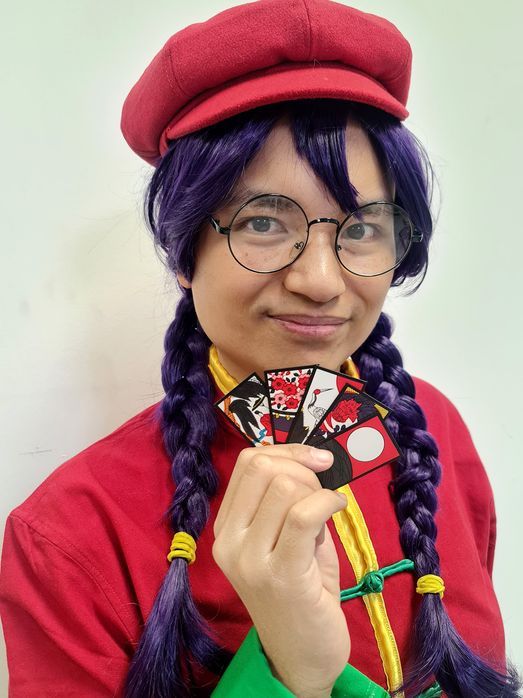 Closeup of cosplay with hanafuda cards, holding up a Five Hikari hand in Koi-Koi.